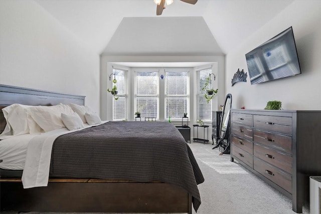 bedroom featuring light carpet, ceiling fan, and vaulted ceiling