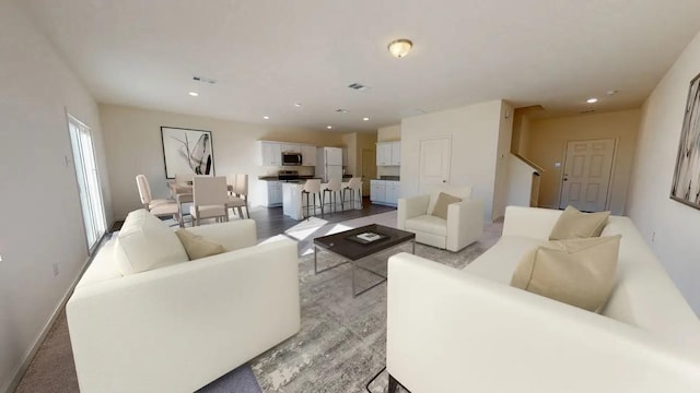 living room featuring recessed lighting, visible vents, and baseboards