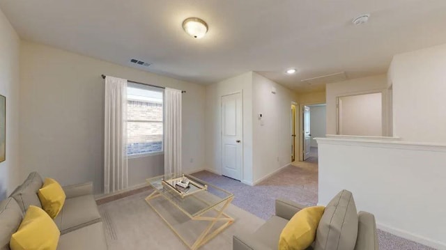 living area with light colored carpet, visible vents, and baseboards