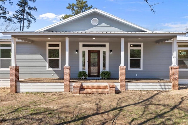 view of front of property featuring a porch and metal roof