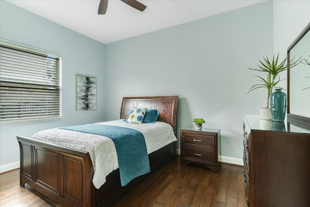 bedroom featuring ceiling fan, baseboards, and dark wood finished floors