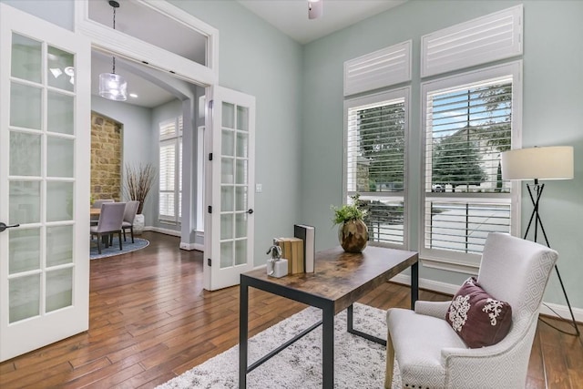 office space with a chandelier, french doors, dark wood-type flooring, and baseboards