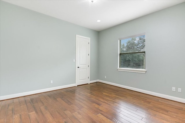 empty room with wood finished floors and baseboards