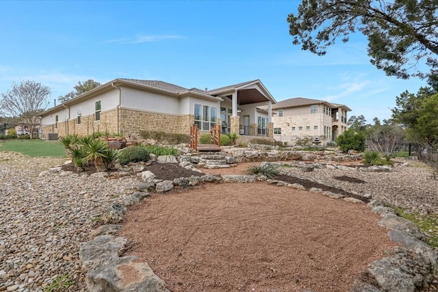 view of front facade with stone siding and stucco siding