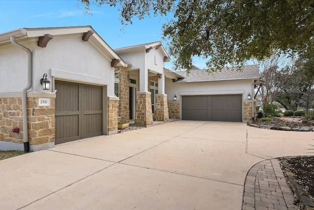 view of front of property featuring a garage, stone siding, concrete driveway, and stucco siding