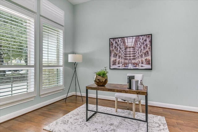 office with plenty of natural light, baseboards, and wood finished floors