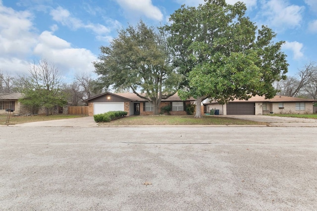 view of front of house with concrete driveway and fence