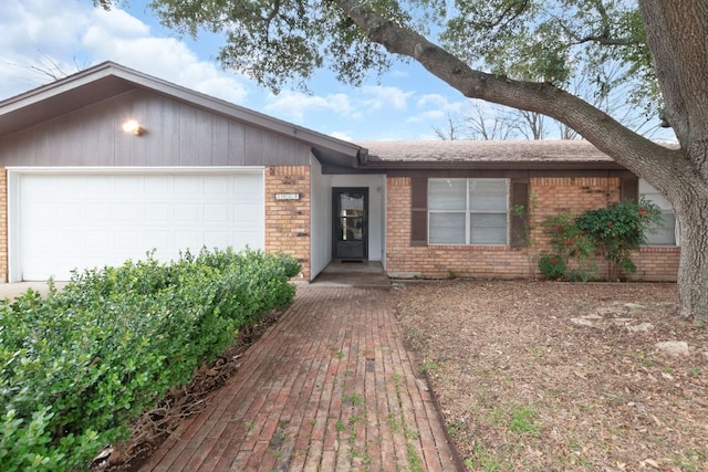 ranch-style house with an attached garage and brick siding