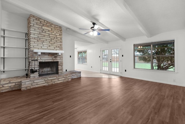 unfurnished living room featuring dark wood-style flooring, french doors, a textured ceiling, and lofted ceiling with beams