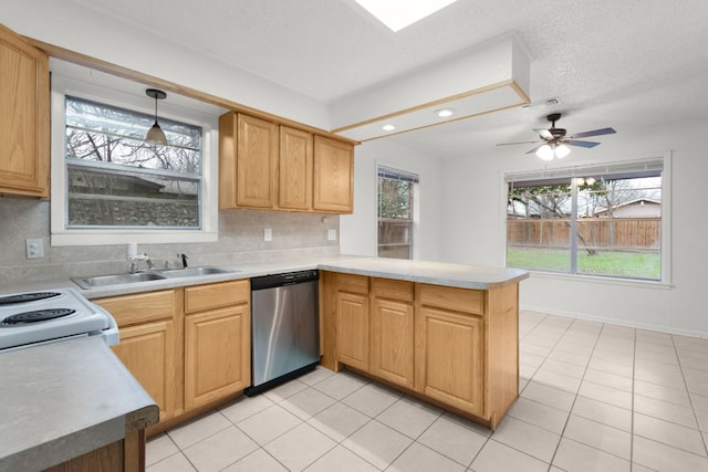 kitchen with light countertops, hanging light fixtures, stainless steel dishwasher, a sink, and a peninsula