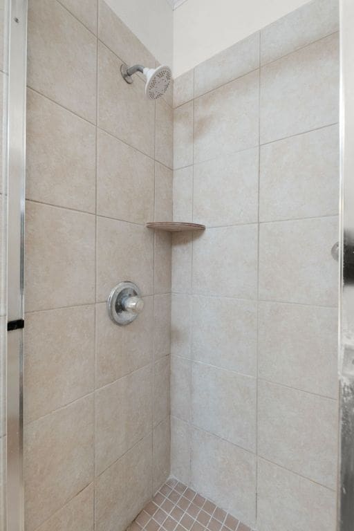 full bath with a shower stall