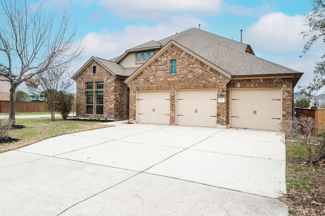 201 Seminole Canyon Dr, Georgetown, TX 78628 - traditional home featuring an attached garage, concrete driveway, brick siding, and a shingled roof