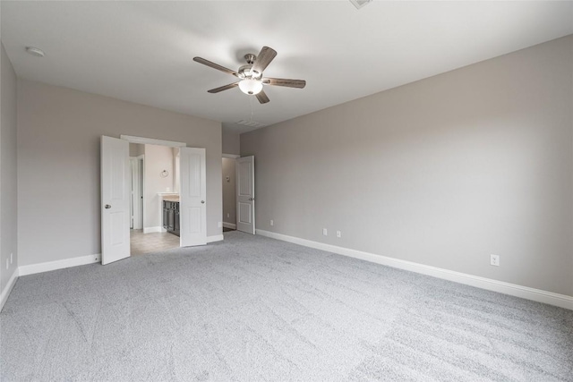 unfurnished bedroom featuring ceiling fan, baseboards, and light colored carpet