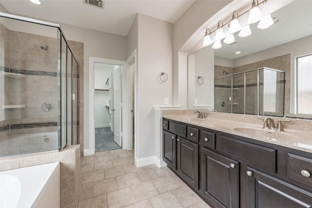 201 Seminole Canyon Dr, Georgetown, TX 78628 - full bath featuring a shower stall, double vanity, a garden tub, and tile patterned flooring
