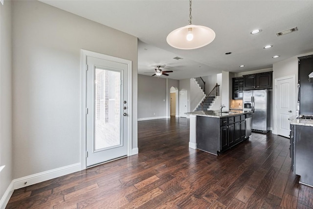201 Seminole Canyon Dr, Georgetown, TX 78628 - kitchen featuring appliances with stainless steel finishes, dark cabinetry, dark wood-style floors, recessed lighting, and a ceiling fan