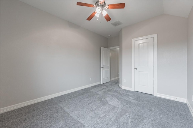 unfurnished bedroom with lofted ceiling, ceiling fan, baseboards, and carpet flooring