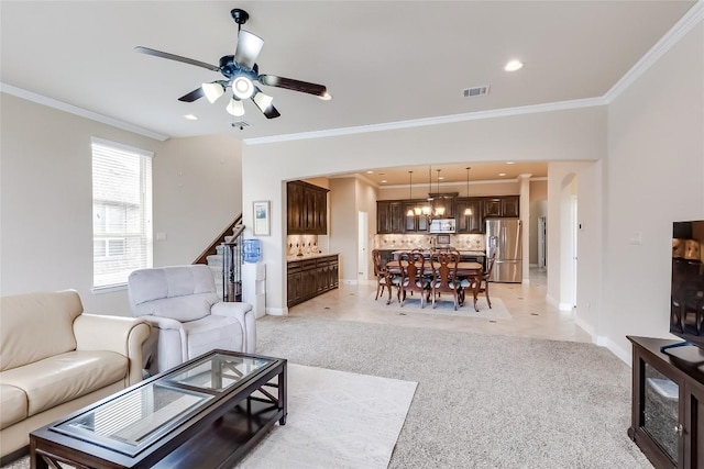 1312 Mustang Brook Ln, Leander, TX 78641 - living room with crown molding, light colored carpet, ceiling fan, stairway, and recessed lighting