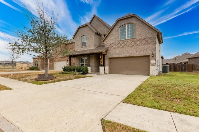 traditional home with an attached garage, cooling unit, fence, concrete driveway, and a front lawn