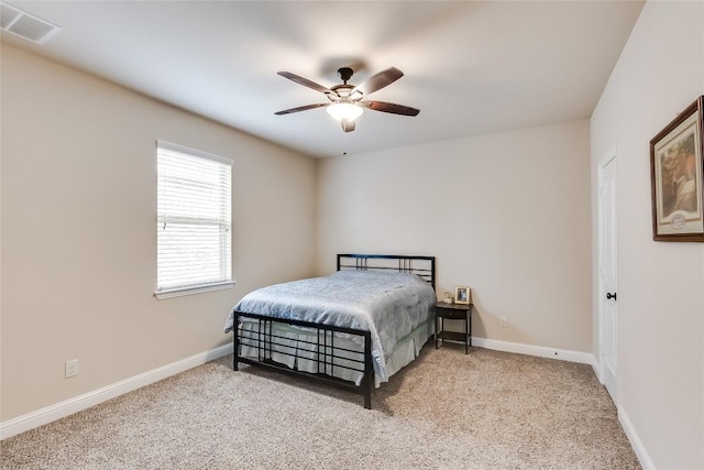 bedroom with light carpet, baseboards, visible vents, and ceiling fan