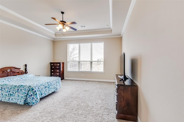 bedroom with visible vents, baseboards, ornamental molding, carpet, and a tray ceiling