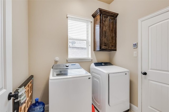 laundry area featuring washer and dryer and cabinet space