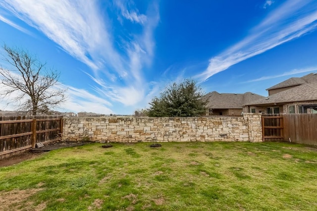 view of yard with a fenced backyard