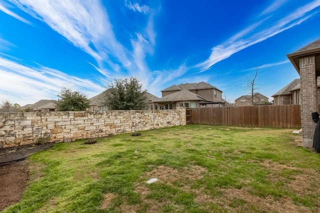 view of yard with a fenced backyard