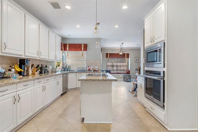 kitchen featuring appliances with stainless steel finishes and white cabinets