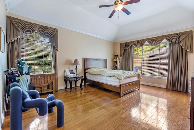 bedroom with light wood-style floors, multiple windows, and baseboards