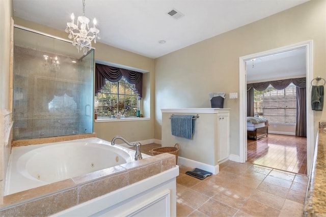 bathroom featuring baseboards, visible vents, ensuite bath, a whirlpool tub, and an inviting chandelier