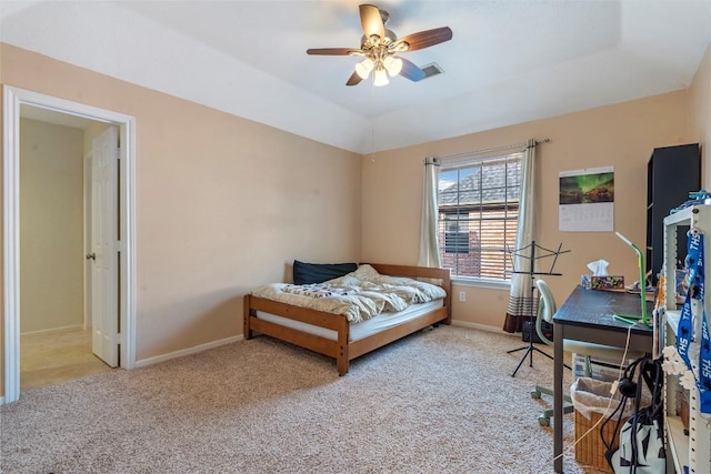 bedroom with light carpet, baseboards, vaulted ceiling, and a ceiling fan