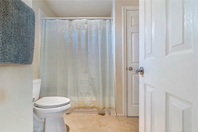 full bath with toilet and tile patterned floors