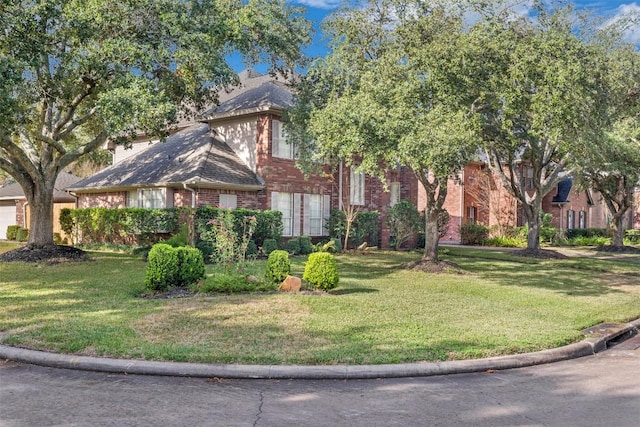 view of front of property with brick siding and a front yard