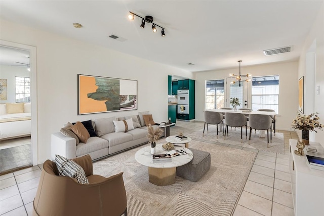400 Cherry Hill Dr, Austin, TX 78704 - living area with light tile patterned floors, visible vents, a healthy amount of sunlight, and a notable chandelier