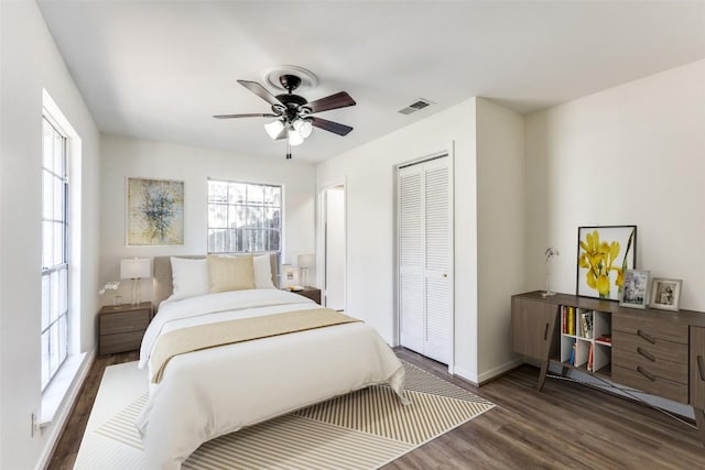 400 Cherry Hill Dr, Austin, TX 78704 - bedroom with multiple windows, a closet, visible vents, and wood finished floors