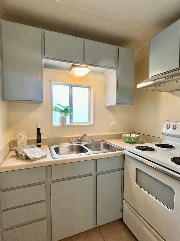 400 Cherry Hill Dr, Austin, TX 78704 - kitchen featuring white range with electric stovetop, light countertops, gray cabinetry, and a sink