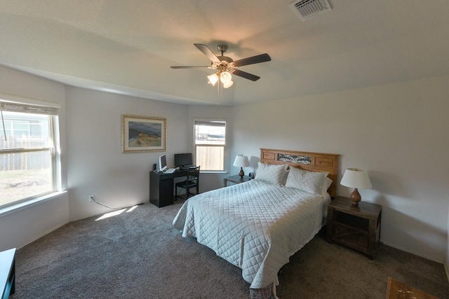 carpeted bedroom with visible vents and a ceiling fan