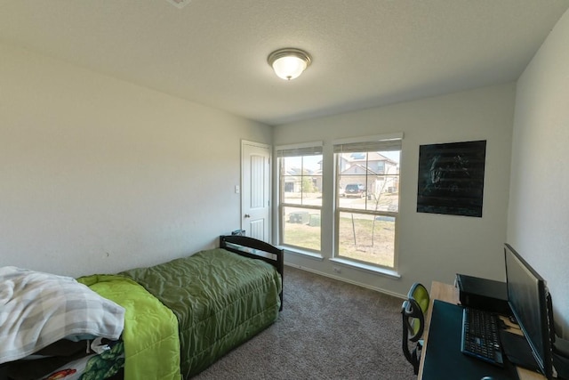 bedroom featuring carpet and baseboards