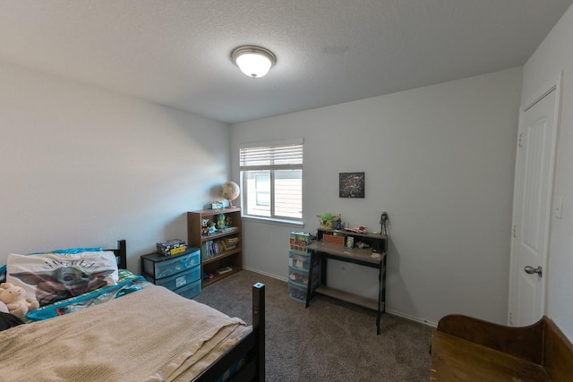 bedroom with dark carpet and baseboards