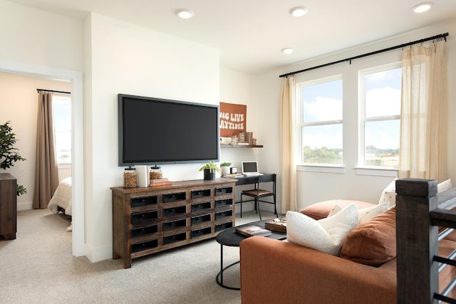 living area with recessed lighting, light colored carpet, and baseboards