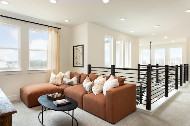 living room featuring recessed lighting, light colored carpet, and baseboards