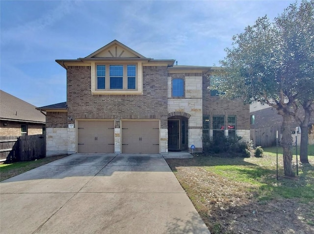 view of front of home with stone siding, brick siding, driveway, and fence