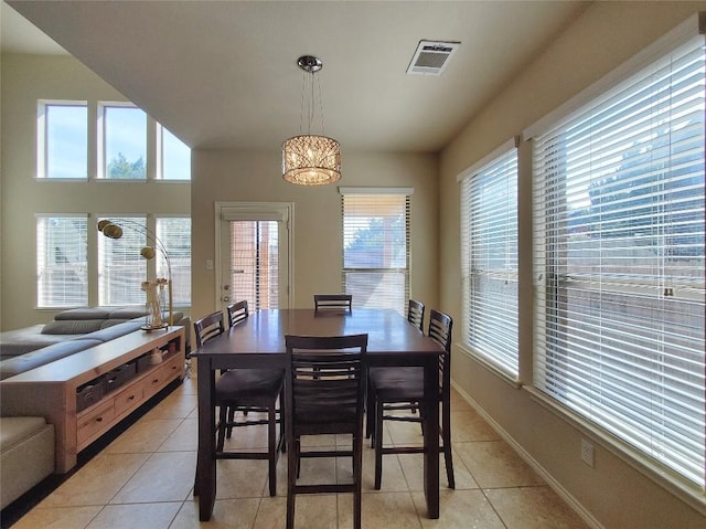 dining space with visible vents, baseboards, and light tile patterned floors