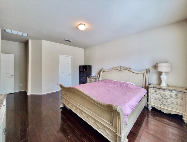 bedroom with baseboards, visible vents, and dark wood-style flooring