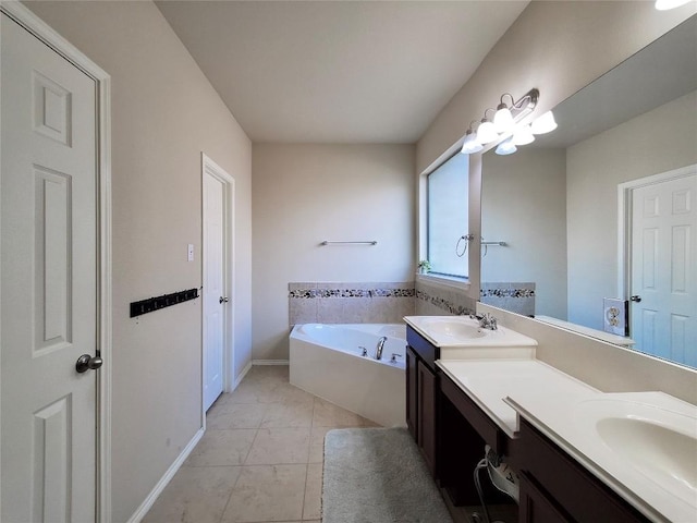 bathroom with a garden tub, a sink, baseboards, and double vanity