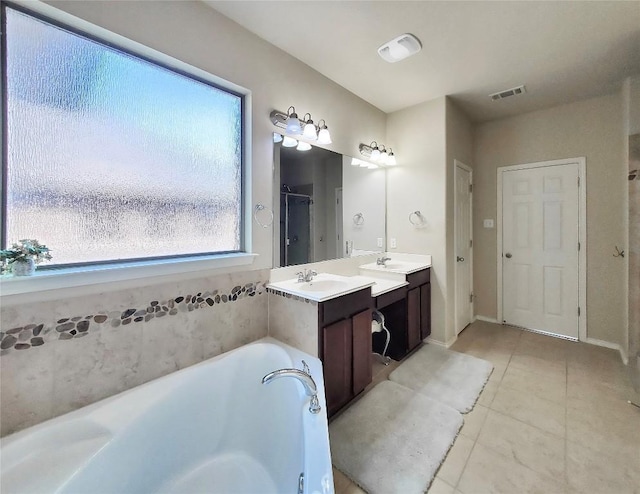 full bath with a garden tub, visible vents, vanity, a shower stall, and tile patterned flooring