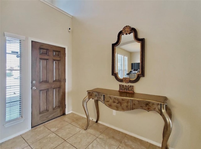 entryway featuring light tile patterned floors and baseboards