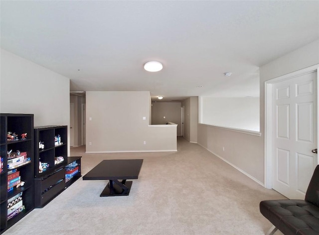 carpeted living room with baseboards