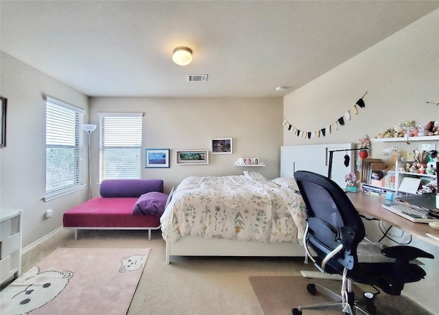 bedroom with visible vents, light carpet, and baseboards