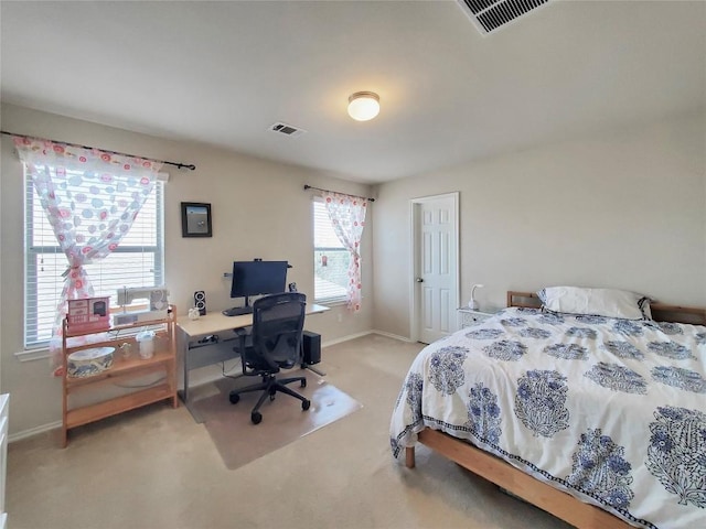 bedroom featuring light colored carpet, visible vents, and baseboards